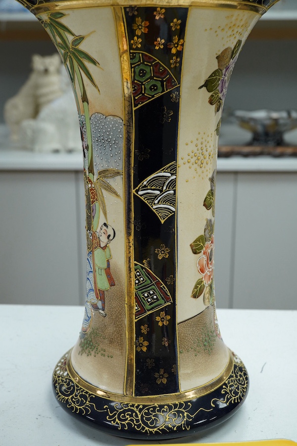 A 20th century Japanese Satsuma pottery trumpet vase decorated with figures, 32cm high. Condition - crazed